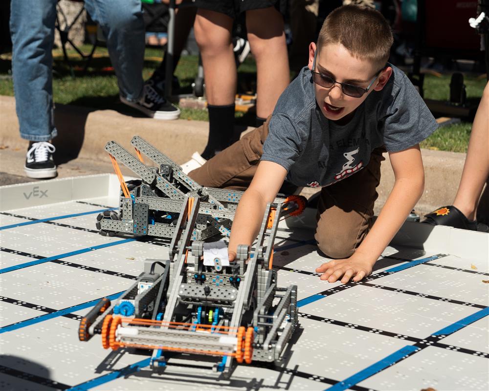 A student with a VEX robot.